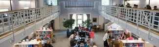 A view from the catwalk in the Portland campus library of students studying in the library